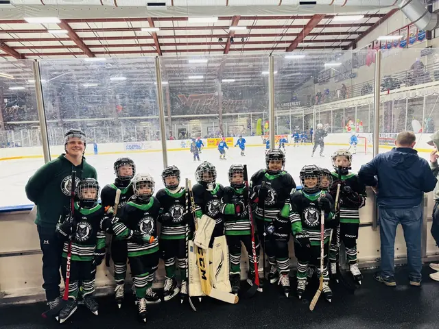 The team lined up along the glass at an away rink