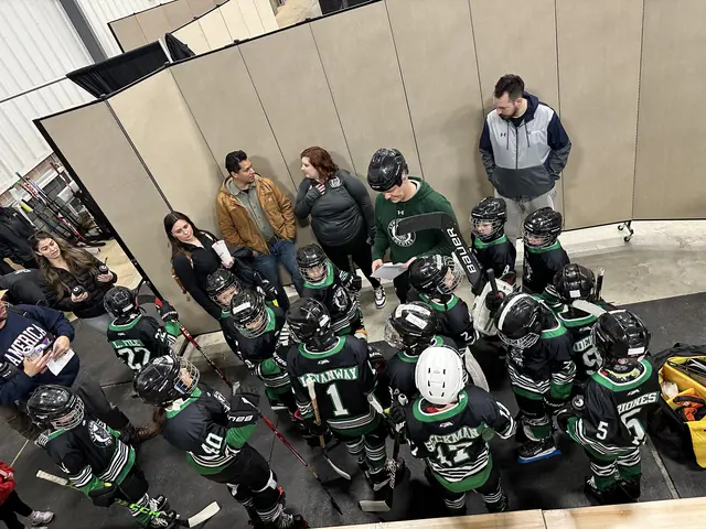 Coaches gather the team for a talk before heading out to the ice